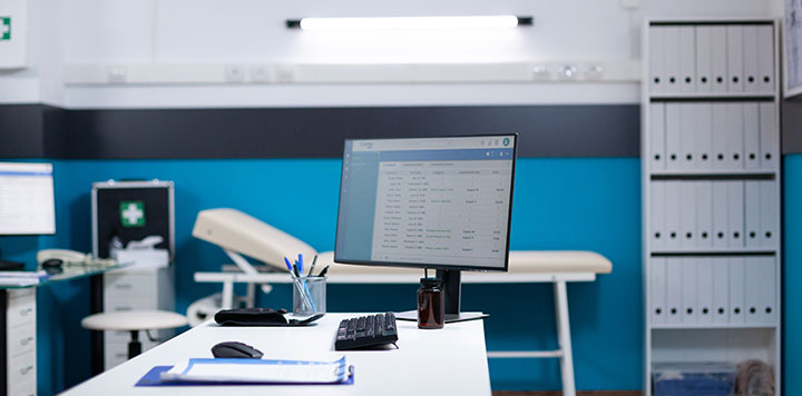 Interior shot of empty healthcare office with computer and medical supplies in the background