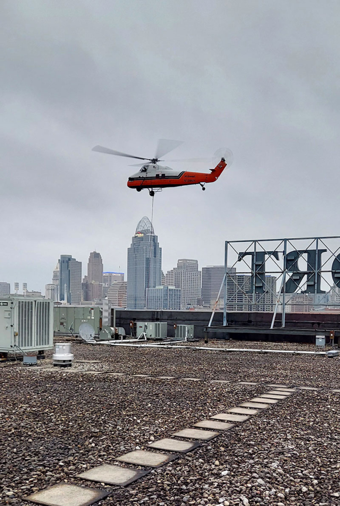 Helicopter flyer over building while installing commercial HVAC system